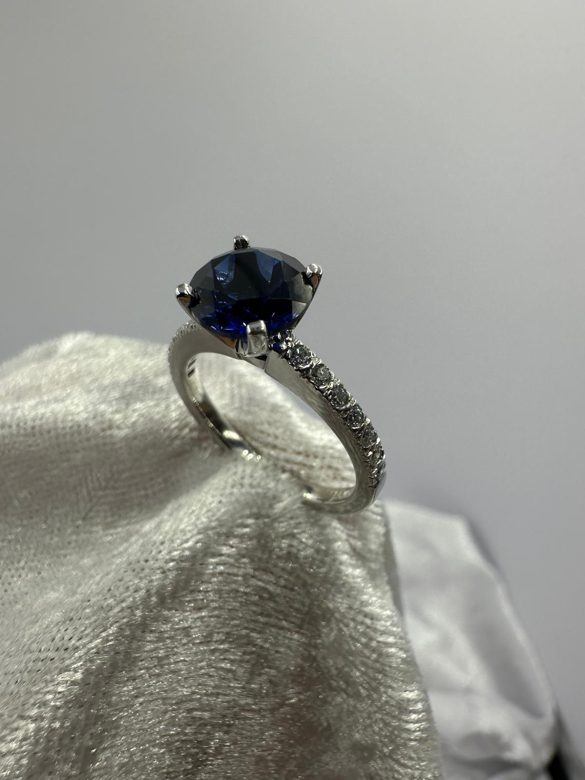 Deep blue round sapphire diamond ring