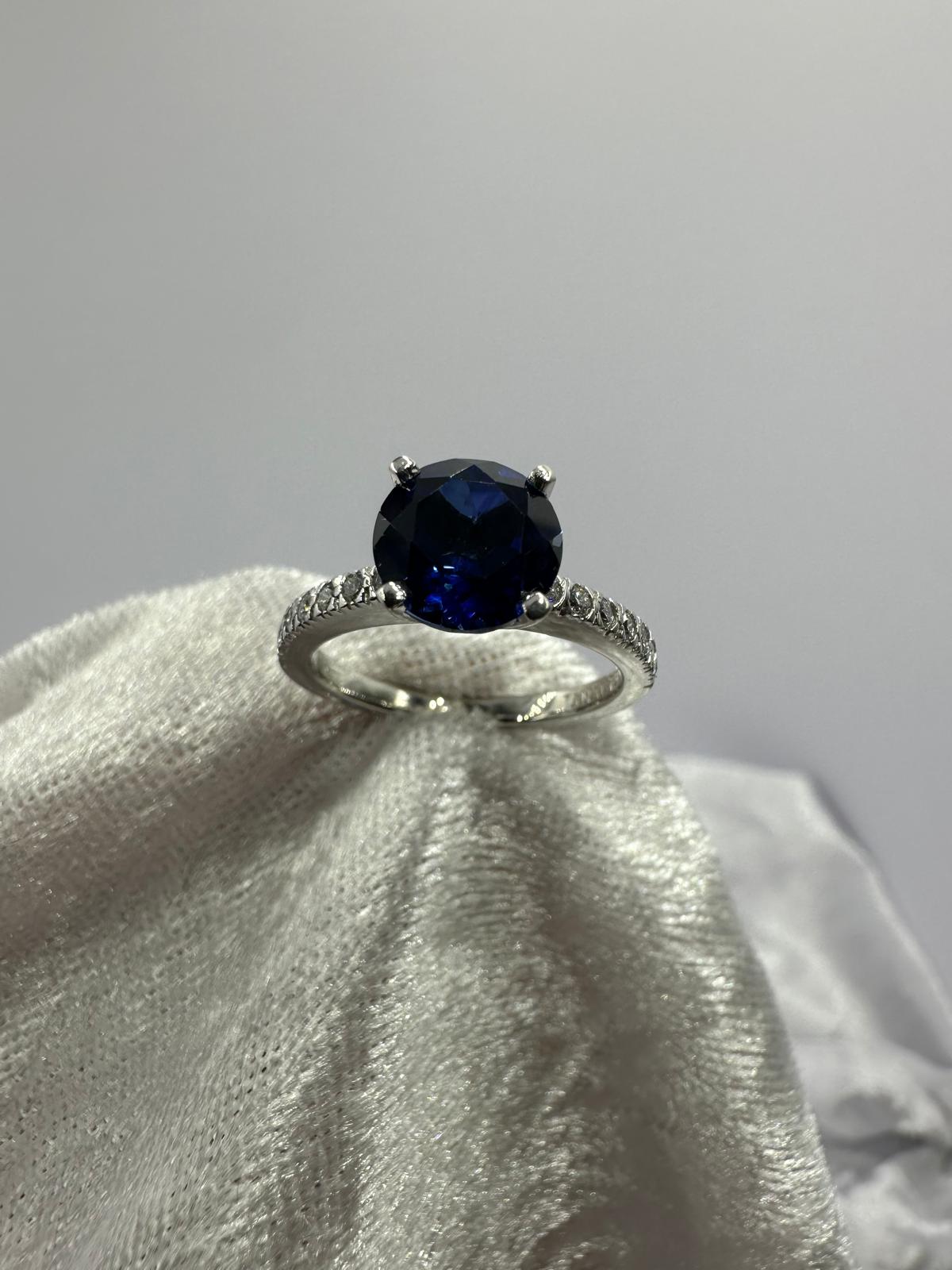 Deep blue round sapphire diamond ring