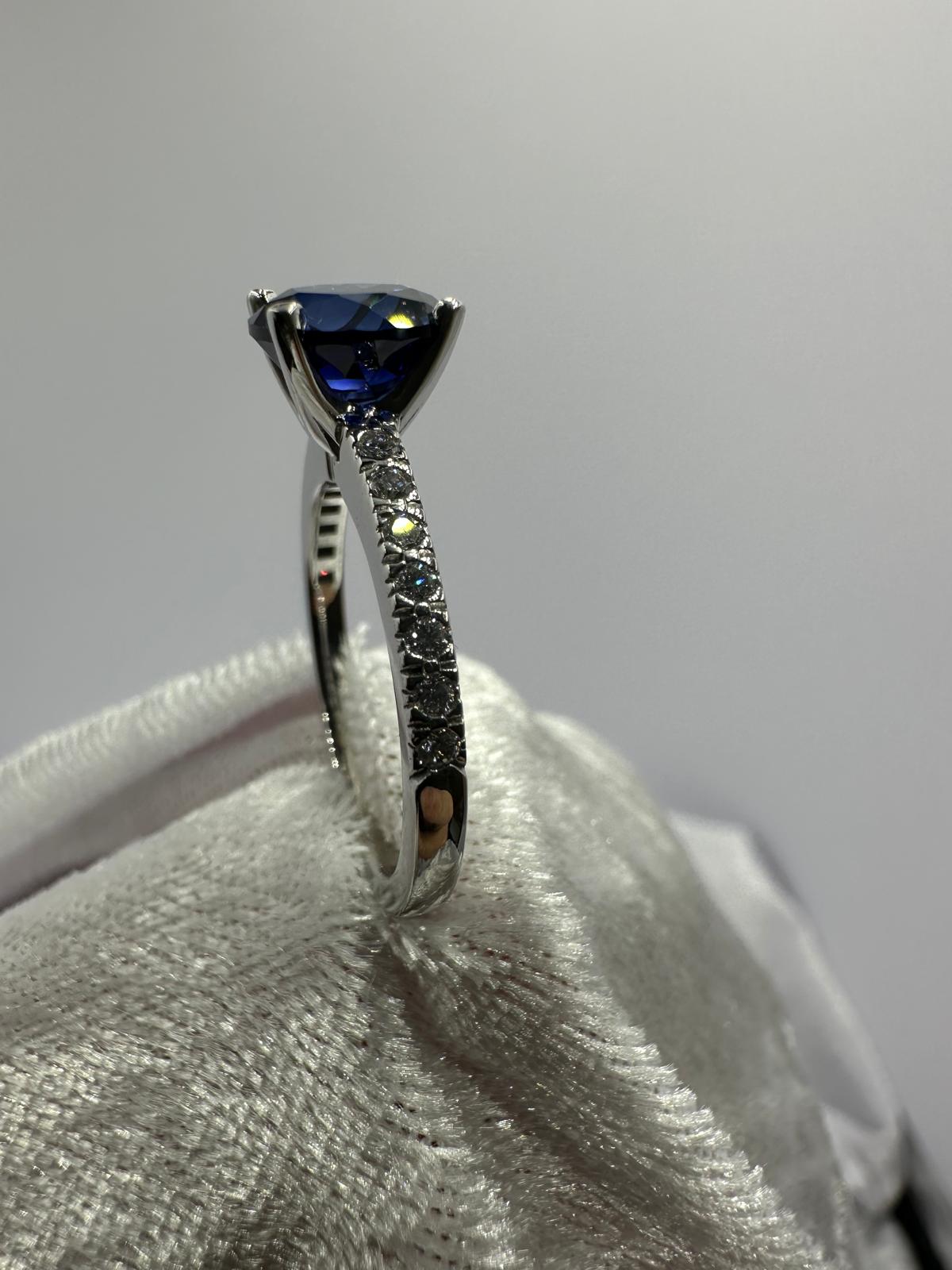 Deep blue round sapphire diamond ring